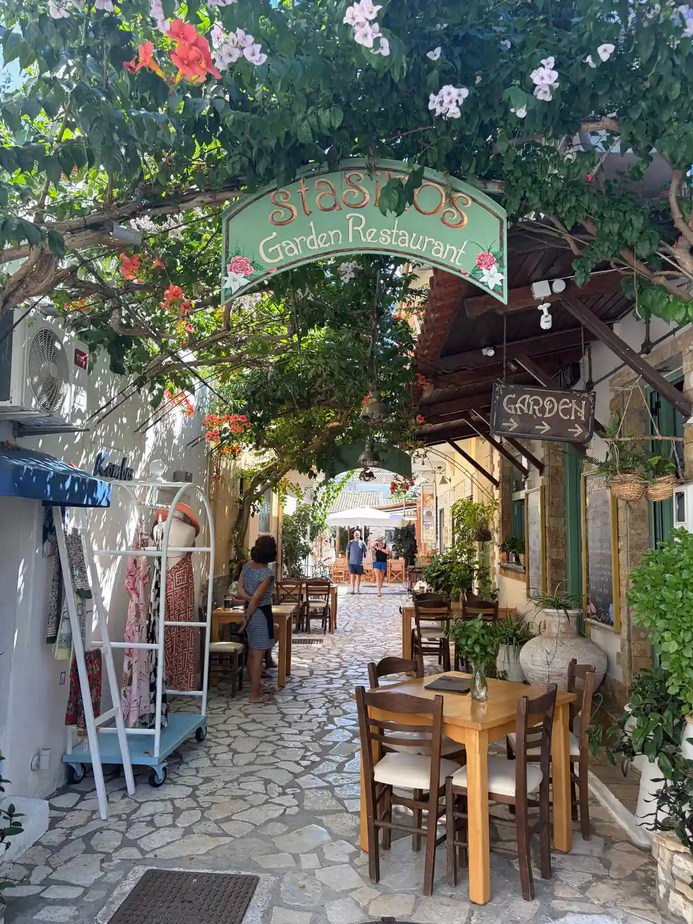 a village restaurant garden entrance shaded by flowers and vines